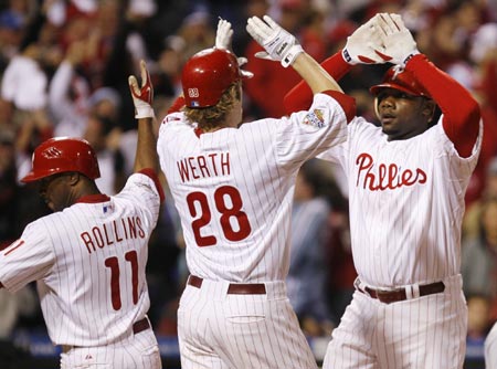 Philadelphia Phillies' Ryan Howard (R) celebrates his three-run home run on the Tampa Bay Rays with teammates Jayson Werth and Jimmy Rollins (L) during the fourth inning in Game 4 of Major League Baseball's World Series in Philadelphia, October 26, 2008.