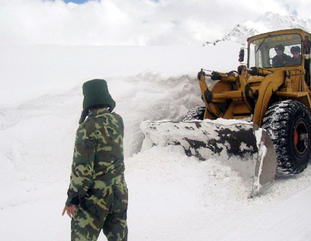 Armed police struggle to clear roads to restore traffic in southwest China's Tibet Autonomous Region on October 27, 2008. Three days of continual heavy snow has blocked the only road leading to Zayu County, a fertile and prosperous area in southeastern Tibet. [Photo: Xinhua]