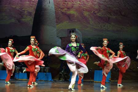 Actresses from China's Xinjiang Mukam Art Troupe show Chinese ethnic culture during their performance in Doha, Qatar Oct. 26, 2008. 