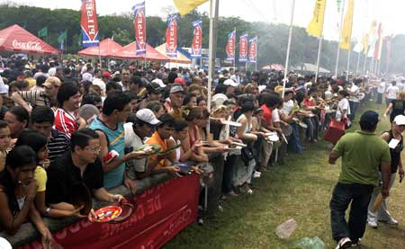 Paraguayans wait to be served barbequed beef after an attempt to create the world&apos;s biggest barbecue in Mariano Roque Alonso near Asuncion Oct. 26, 2008.