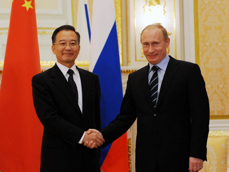 Chinese Premier Wen Jiabao and Russian Prime Minister Vladimir Putin held talks here Tuesday and pledged to further cooperation to cope with the global financial crisis.