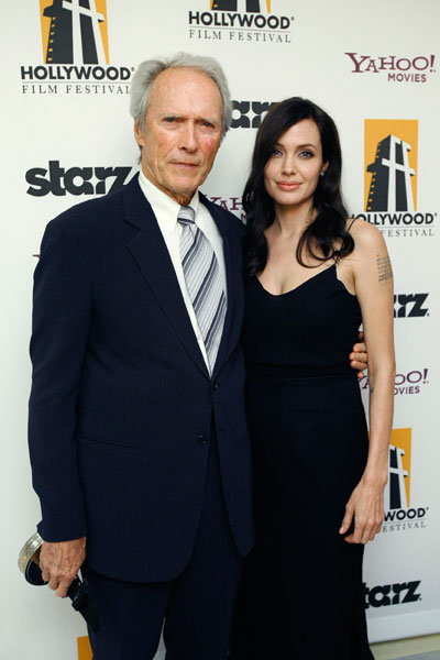 Actor and director Clint Eastwood poses with presenter Angelina Jolie after he accepted the award for Director of the Year at the 12th annual Hollywood Awards gala in Beverly Hills, California October 27, 2008.