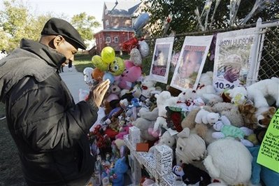 Elijah Daniels prays at a makeshift memorial Tuesday, Oct, 28, 2008.