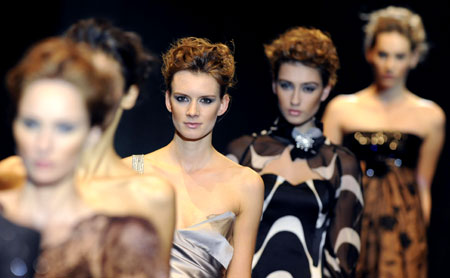 Models present part of the women's 2009 collection 'For Weronika' by Polish fashion designer Teresa Rosati during a fashion show at Warsaw Polytechnic building in Warsaw, October 28, 2008.