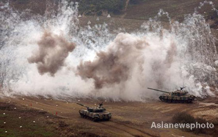 Armored vehicles participate an attacking drill in Central China's Henan Province October 28,2008. The armored brigade stationed in Jinan of East China's Shandong Province conducted a filed operation on attacking in mountainous area. [Asiannewsphoto]