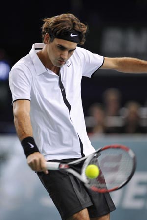 Roger Federer of Switzerland returns the ball to Robin Soderling of Sweden during their match at the Paris Masters Series tennis tournament October 29, 2008.