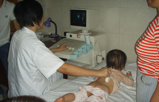 In the picture taken in late September a doctor in the Pingchang People's Hospital in southwest China's Sichuan Province conducts B-type ultrasonic scans for a child.