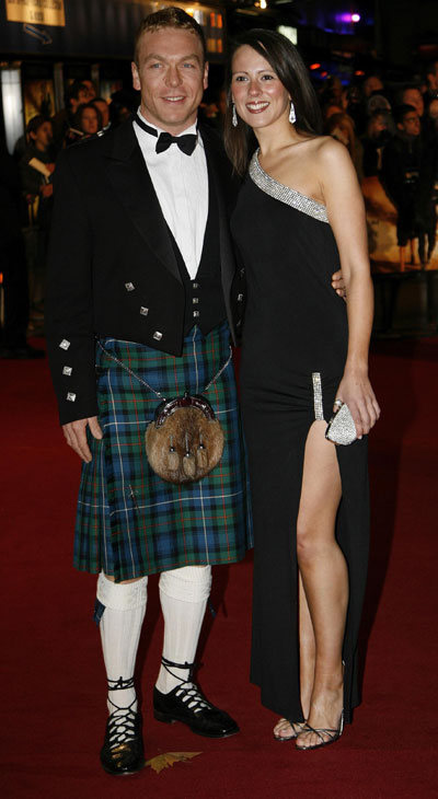 British Olympic cyclist Chris Hoy (L) arrives with an unidentified guest for the world premiere of the latest James Bond movie 'Quantum of Solace' at Leicester Square in London October 29, 2008.