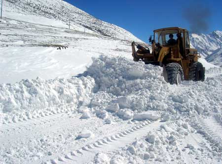  A bulldozer cleans snow on the Sichuan-Tibet road in Nyingchi, southwest China&apos;s Tibet Autonomous Region Oct. 30, 2008.