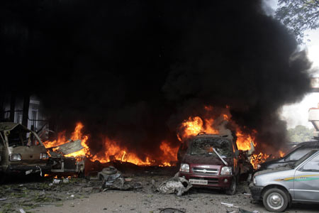 Damaged cars are seen at a bomb blast site in Guwahati, the main city of India&apos;s troubled northeastern Assam state, Oct. 30, 2008. [Xinhua/Reuters]