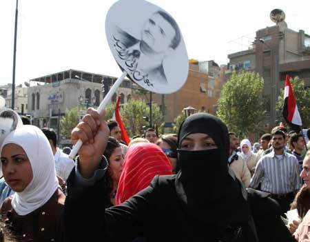 Syrian students shout slogans against the U.S. as they wave an image of President Bashar al-Assad during a demonstration in Damascus Oct. 30, 2008.(