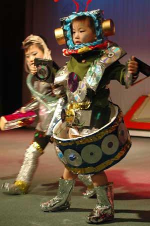 Two children present fashion creations during an environment-friendly fashion show in Wuhu, east China&apos;s Anhui Province, Oct. 30, 2008. 