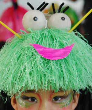 A child presents a headwear creation during an environment-friendly fashion show in Wuhu, east China&apos;s Anhui Province, Oct. 30, 2008. [Xinhua]