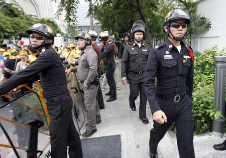 Thai policemen guard outside the British Embassy in Bangkok, capital of Thailand, in the morning of Oct. 30, 2008. Anti-government protesters rally here to demand an extradition of Thai former prime minister Thaksin Shinawatra.