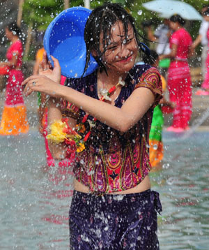 A girl reacts during a water-splashing festival in Dai Autonomous Prefecture of Xishuangbanna, southwest China's Yunnan Province Oct. 30, 3008. [Xinhua] 