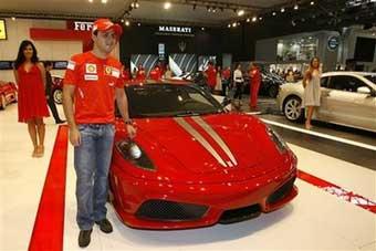 Ferrari's Felipe Massa of Brazil poses next to a Ferrari F-430 during the International Car Showroom in Sao Paulo, Wednesday, Oct. 29, 2008. Another Formula One season has come down to the last race, with McLaren's Lewis Hamilton and Ferrari's Felipe Massa vying for a first career title at the Brazilian Grand Prix on Sunday.[AP Photo] 