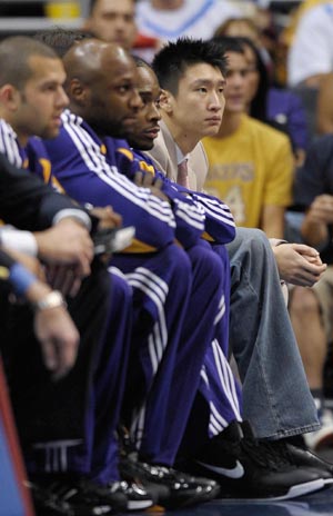 Lakers rookie Sun Yue (1st R. Front) of China watches the NBA basketball game between Lakers and Clippers at Staples Center, Los Angeles, CA, the U.S.A., Oct. 29, 2008.