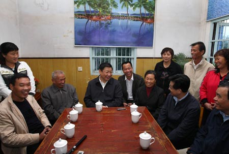 Chinese Vice President Xi Jinping (4th L), member of the Standing Committee of the Political Bureau of the Communist Party of China (CPC) Central Committee, talks with local villagers in Gaocheng village of Dingqiao Town in Hangzhou, capital of east China's Zhejiang Province, Oct. 31, 2008. [Xinhua]