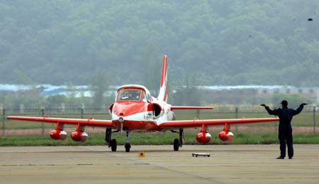 A plane of Suryakiran, or sun rays in Hindi, an aerobatics demonstration team of the Indian Air Force, arrives in Zhuhai, south China's Guangdong Province, Oct. 31, 2008. [Xinhua]