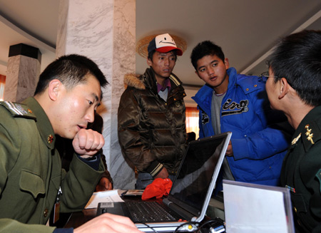 Two young men consult during a military recruitment in Lhasa, capital of southwest China's Tibet Autonomous Region Nov. 1, 2008. China's People's Liberation Army (PLA) started the yearly and nationwide winter recruitment on Saturday. [Xinhua] 