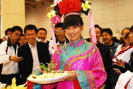 A girl shows a dish during the third China International Food Festival kicked off Saturday in Yantai, east China's Shandong Province, November 1, 2008. (Xinhua Photo) 