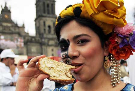 Itayetzy tastes bread at the Zocalo square during a bread-making contest special for the day of the dead in Mexico city Nov. 2, 2008.