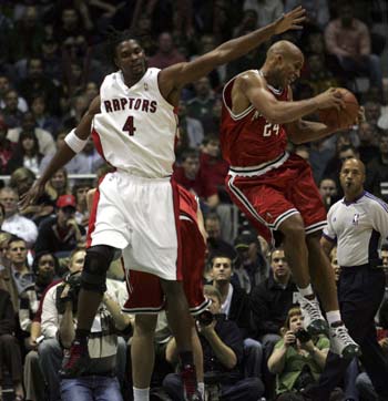 Milwaukee Bucks forward Richard Jefferson (24) pulls down a defensive rebound in the first quarter with Toronto Raptors forward Chris Bosh (4) defending during NBA basketball action in Milwaukee, Wisconsin November 1, 2008.