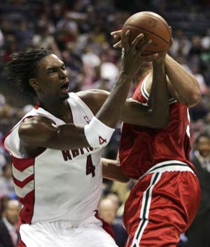 Toronto Raptors forward Chris Bosh (4) is fouled by Milwaukee Bucks center Dan Gadzuric (R) from Holland as he shoots in the second quarter during NBA basketball action in Milwaukee, Wisconsin November 1, 2008.