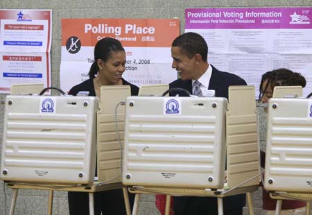 U.S. Democratic presidential nominee Senator Barack Obama (D-IL) and his wife Michelle vote in the U.S. presidential election at the Beulah Shoesmith Elementary School in Chicago, Nov. 4, 2008. [Xinhua/Reuter]