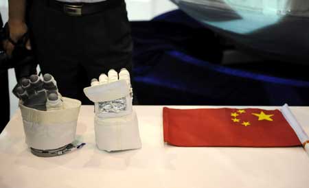  Gloves and a Chinese national flag used by the Taikonauts of the Shenzhou-7 are shown at the 7th China International Aviation and Aerospace Exhibition in Zhuhai, south China&apos;s Guangdong Province, Nov. 3, 2008.