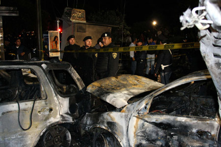 Policemen keep guard near the wreckage of the vehicles at the site of a plane crash in Mexico City, capital of Mexico, Nov. 4, 2008.