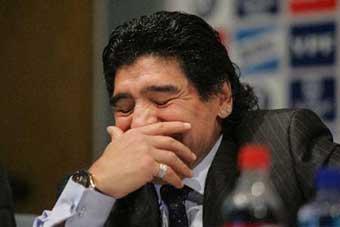 Diego Maradona reacts at the news release conference. Soccer legend Diego Maradona said that he had 'fulfilled a dream' after officially taking over Argentina's national soccer team on Tuesday. [Xinhua Photo]