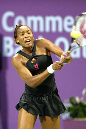 U.S.A.'s Venus Williams returns the ball to Russia's Dinara Safina during the first round of Sony Ericsson Tennis Championship at the Khalifa stadium in Doha, Qatar, Tuesday Nov. 4, 2008. Williams won 7-5, 6-3.
