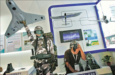 An exhibitor at the aviation show in Zhuhai demonstrates a made-in-China Unmanned Aerial Vehicle. The hi-tech piece of kit is designed to carry heavy weapons but can be operated by a single soldier. 