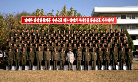 Undated photo shows Kim Jong Il(C), top leader of the Democratic People&apos;s Republic of Korea (DPRK), poses for group photos with army officers and soldiers of the 534th unit of the People&apos;s Army during an inspection. [Xinhua/KCNA]