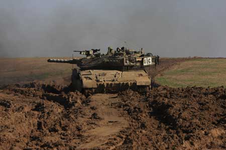  An Israeli tank runs on the Israel-Gaza border, Nov. 5, 2008.