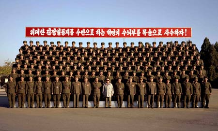 Undated photo shows Kim Jong Il(C), top leader of the Democratic People&apos;s Republic of Korea (DPRK), poses for group photos with army officers and soldiers of 2200th unit of the People&apos;s Army during the inspection.