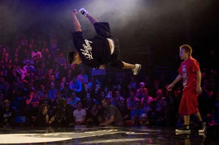 Lil Ceng (L) of Germany performs as Taisuke of Japan watches during the Red Bull BC One break-dance competition, in which 16 B-Boys from across the world compete in one-on-one knockout battles to determine the winner, in Paris November 5, 2008.