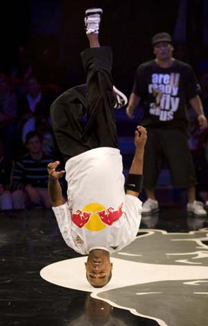 Pelezinho (L) of Brazil performs as Lil Ceng of Germany watches during the Red Bull BC One breakdance competition, in which 16 B-Boys from across the world compete in one-on-one knockout battles to determine the winner, in Paris November 5, 2008.