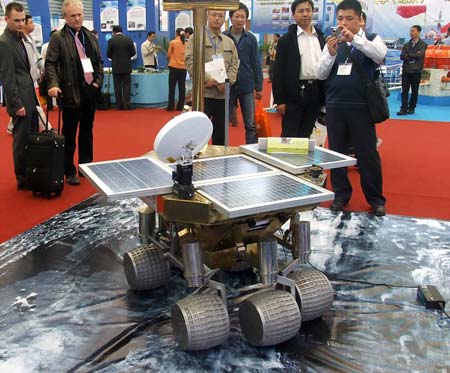 Some visitors are attracted by a "Moon Walker" designed by Beijing University of Technology at the 2008 Shanghai International Industry Fair opened in Shanghai, China, Nov. 4, 2008. Covering an area of over 120,000 square meters, the exhibition attracted a total of 1816 companies from 25 countries and regions, and served as the largest of its kind in history as the fair has come to its 10th year.