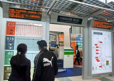 Some visitors watch an "Intelligent Bus Stop" exhibited at the 2008 Shanghai International Industry Fair opened in Shanghai, China, Nov. 4, 2008. Covering an area of over 120,000 square meters, the exhibition attracted a total of 1816 companies from 25 countries and regions, and served as the largest of its kind in history as the fair has come to its 10th year.