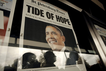 People look at newspaper front pages from around the world telling of the election victory of President-elect Senator Barack Obama at the Newseum in Washington November 5, 2008. [Xinhua]