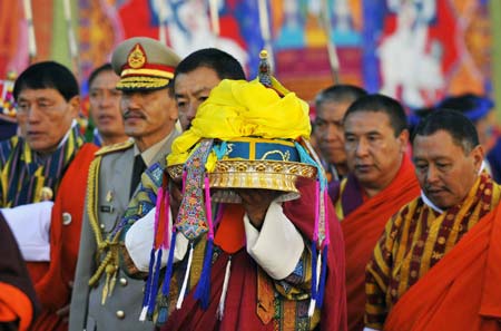 Secretary of the fifth king of Bhutan, Jigme Khesar Namgyel Wangchuck, carries the crown to a temple during the coronation ceremony in Thimphu, Bhutan, Nov. 6, 2008. 