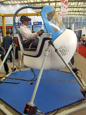 A visitor tries a flight simulator designed by Nanjing University of Aeronautics and Astronautics at the 2008 Shanghai International Industry Fair opened in Shanghai, China, Nov. 4, 2008. Covering an area of over 120,000 square meters, the exhibition attracted a total of 1816 companies from 25 countries and regions, and served as the largest of its kind in history as the fair has come to its 10th year.
