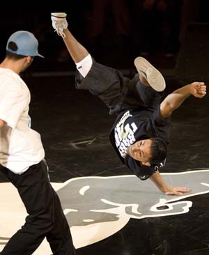 Lil Ceng (R) of Germany performs as Kid David of the U.S. watches during the Red Bull BC One break-dance competition, in which 16 B-Boys from across the world compete in one-on-one knockout battles to determine the winner, in Paris November 5, 2008.