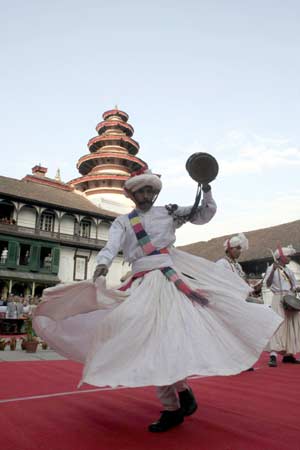 Nepalese ethnic cultural group from mid-western Nepal perform traditional dance 'Kaura Naach' during the International Folk Music Festival in Kathmandu, capital of Nepal, on Nov. 7, 2008. [Xinhua]