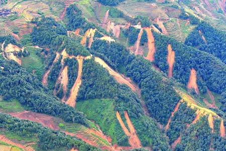 An aerial view shows roads and vegetation are devastated by landslides and mud-flows in Chuxiong Yi Autonomous Prefecture of southwest China's Yunnan Province, in this photo taken on November 6, 2008. 