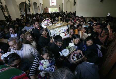Bolivians carry skulls into a church during a ceremony on the Day of Skulls in the General Cemetery of La Paz November 8, 2008.
