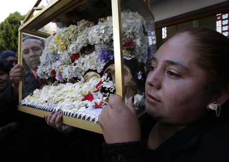 Devotees carry skulls during a ceremony on the Day of Skulls at a church in the General Cemetery of La Paz November 8, 2008.
