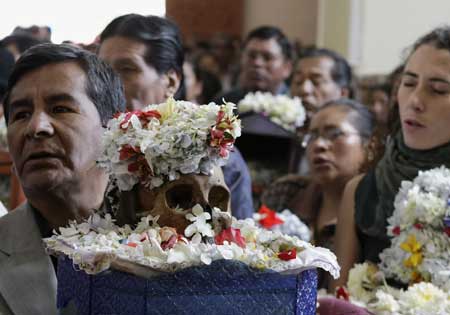 People attend a ceremony on the Day of Skulls at a church in the General Cemetery of La Paz November 8, 2008.